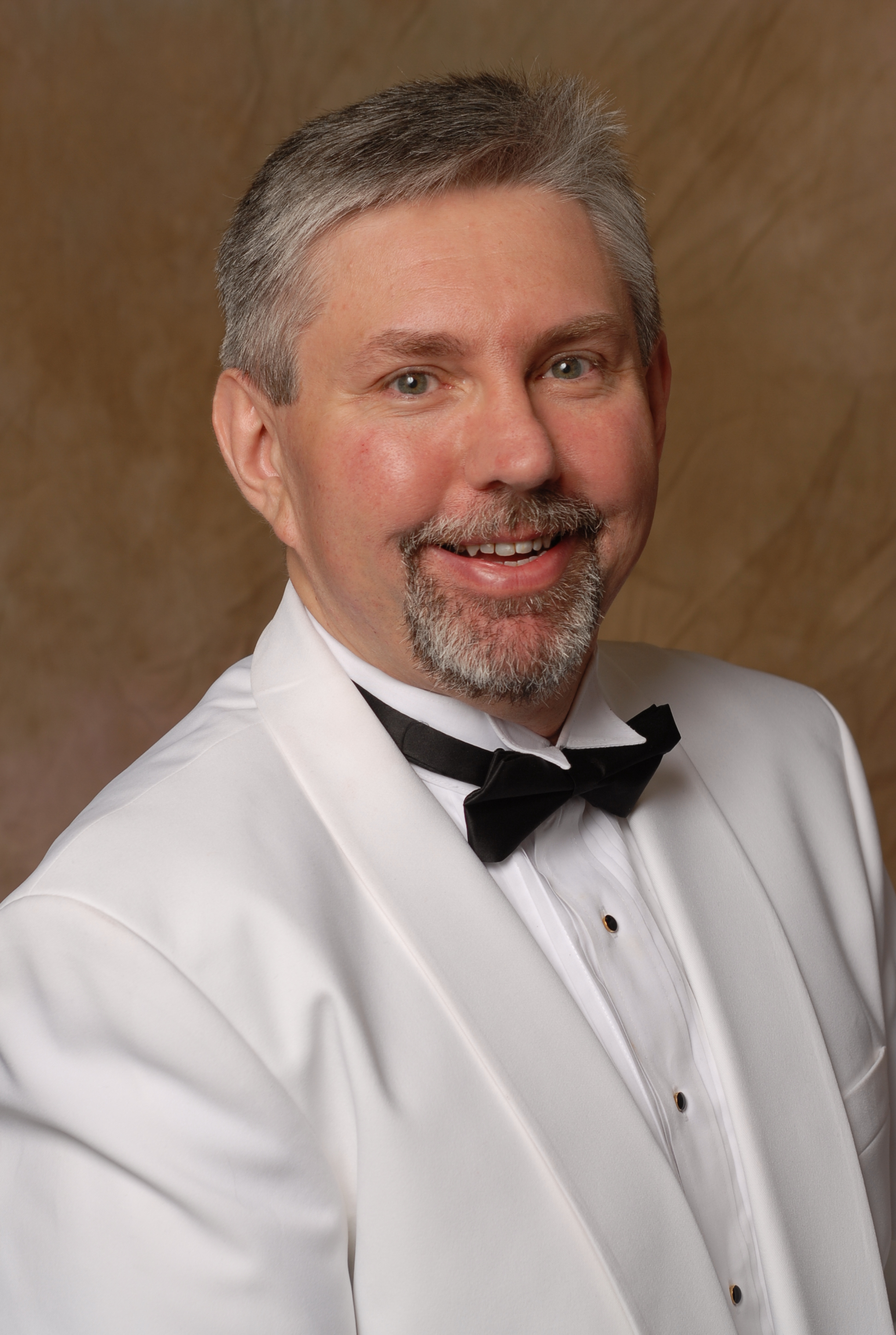 Dr. Frank Pittman seated at a grand piano